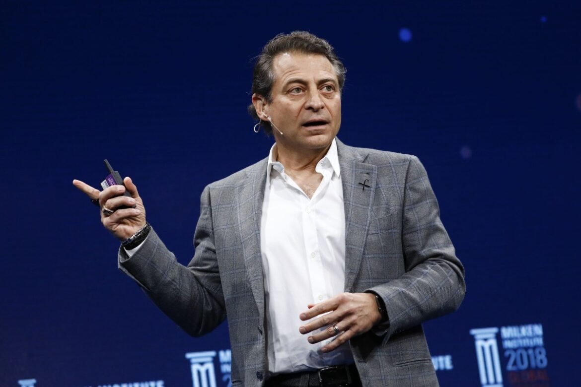 Peter Diamandis on stage pointing off camera